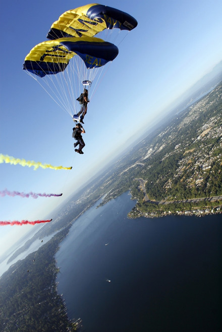Members of the U.S. Navy Parachute Team, the Leap Frogs, perform a bi-plane with their parachutes above Seattle Print - Item # VARPSTSTK103180M