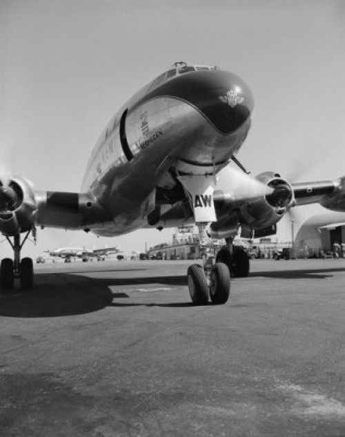 Commercial plane  airport building in the background Poster Print - Item # VARSAL255418498