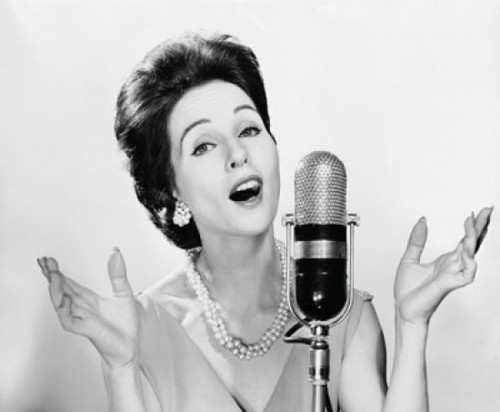Young woman singing into a microphone Poster Print - Item # VARSAL2553365B