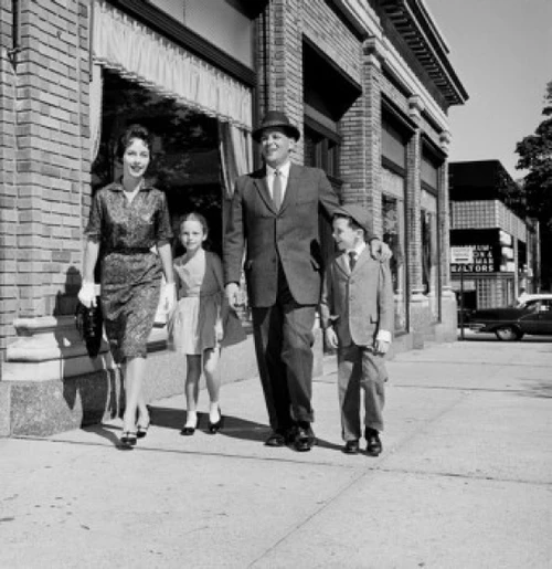Parents and kids walking down street Poster Print