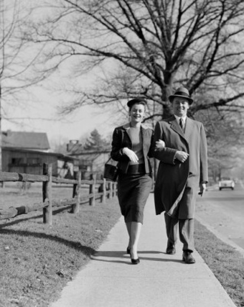 Mid adult couple walking down street Poster Print - Item # VARSAL255421869
