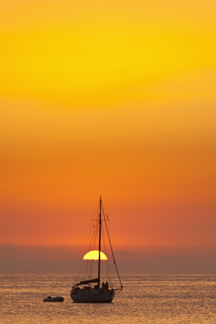 Spain, People watching sunset from yacht moored off Benirras beach; Ibiza PosterPrint - Item # VARDPI2296248