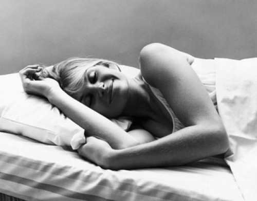 Young woman sleeping in the bed and smiling Poster Print
