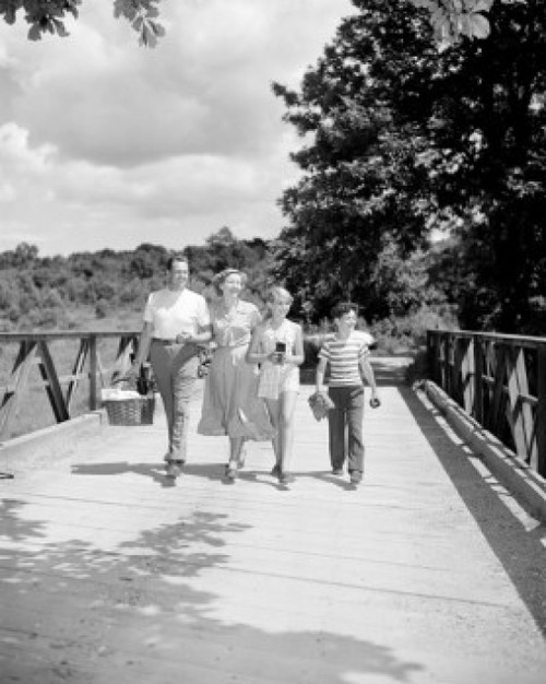 Parents with son and daughter walking on bridge Poster Print - Item # VARSAL255419243
