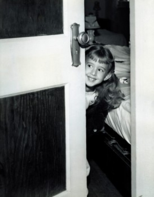 Girl peering around bedroom door Poster Print - Item # VARSAL25514325