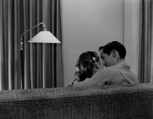 Young couple kissing on sofa  rear view Poster Print - Item # VARSAL255421697