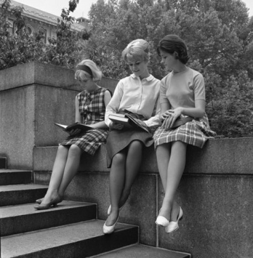 Tree young students sitting on wall and reading books Poster Print - Item # VARSAL255417416