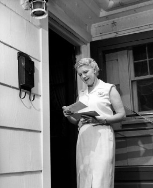 Woman reading letter on porch Poster Print - Item # VARSAL25549047