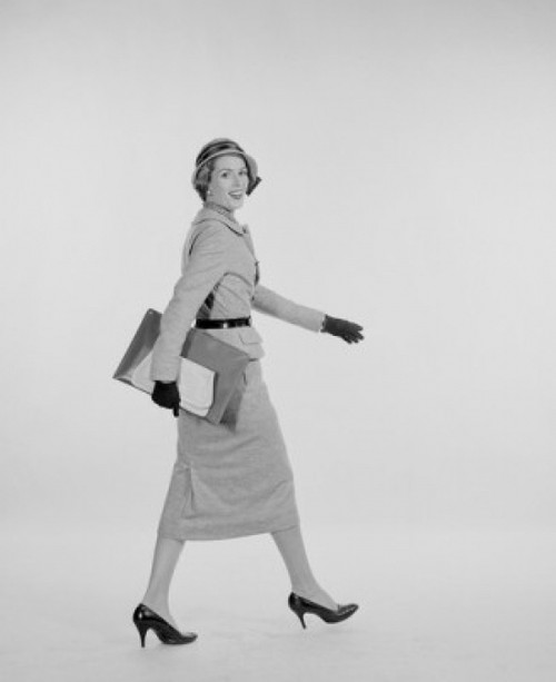 Portrait of elegant young woman walking  studio shot Poster Print - Item # VARSAL255419953
