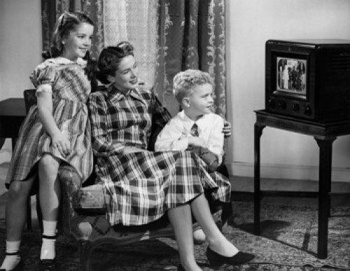 Mid adult woman with son and daughter watching television Poster Print - Item # VARSAL2553144