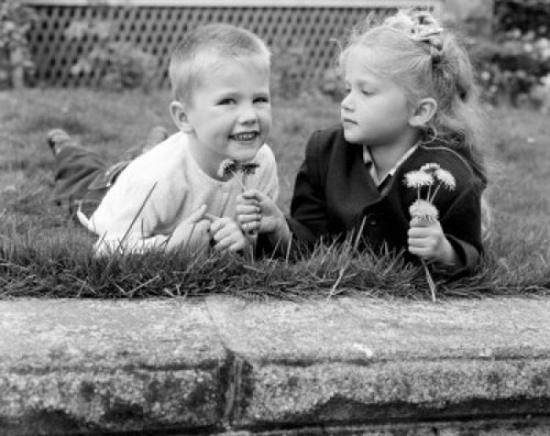 Girl and boy picking flowers Poster Print
