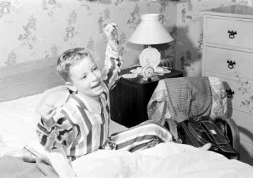 Boy stretching in bed Poster Print
