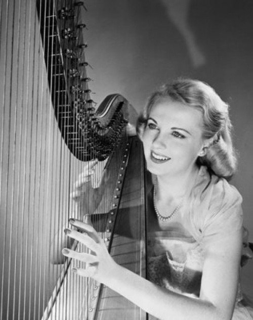 Young woman playing a harp and smiling Poster Print - Item # VARSAL2553364C