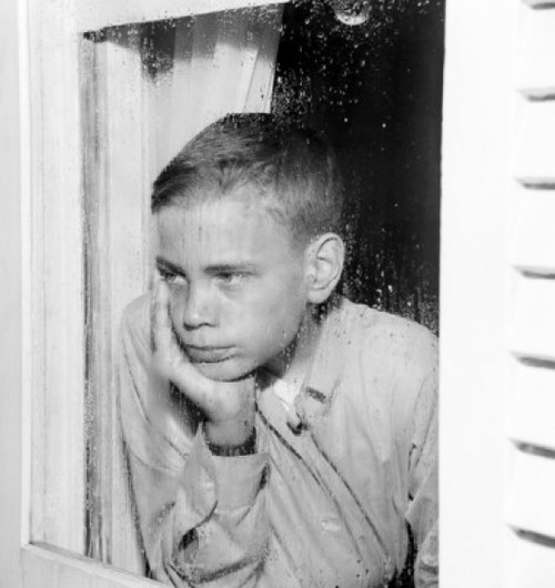 Sad boy looking through window Poster Print - Item # VARSAL255417700