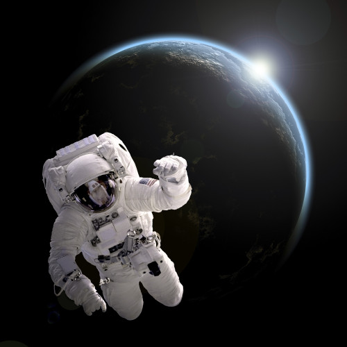 Artist's concept of an astronaut floating in outer space. An Earth-like planet sees sunrise in the background. Poster Print - Item # VARPSTMRC200106S