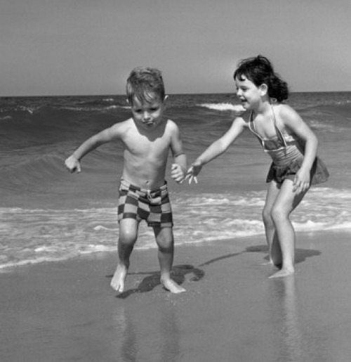 Boy and girl playing on sandy beach Poster Print - Item # VARSAL255421041