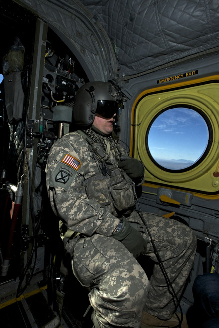 Crew chief looking out the window of a CH-47 Chinook while in flight to Playas Training Area, New Mexico, during exercise Angel Thunder 2013 Poster Print - Item # VARPSTTMO101131M