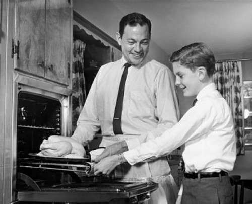 Mid adult man with his son putting a turkey into an oven Poster Print - Item # VARSAL25535517 Mid adult man with his son putting a turkey into an oven Poster Print - Item # VARSAL25535517