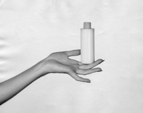 Close-up of a woman's hand holding a bottle of moisturizer Poster Print - Item # VARSAL25549491