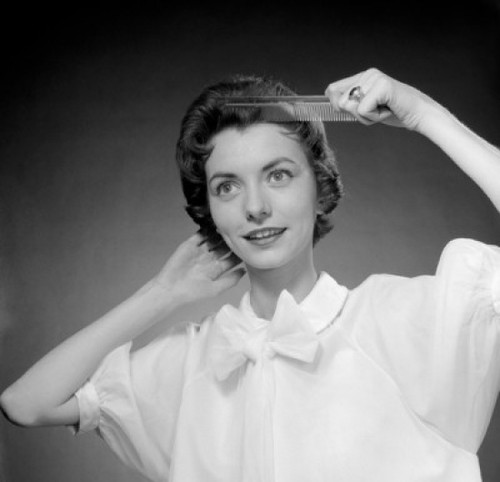 Portrait of woman combing hair Poster Print - Item # VARSAL255416799