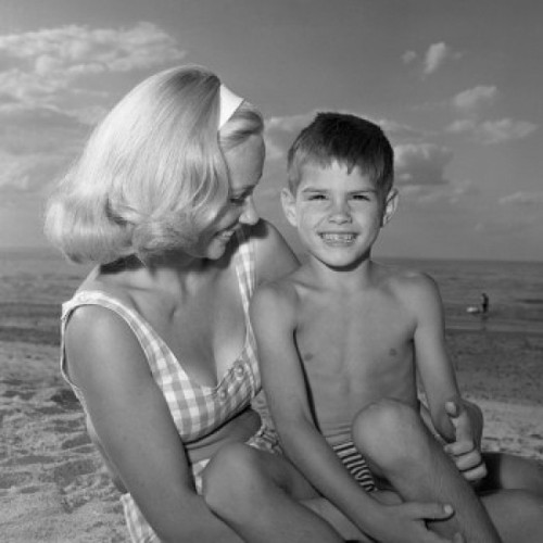 Mother and son on beach Poster Print