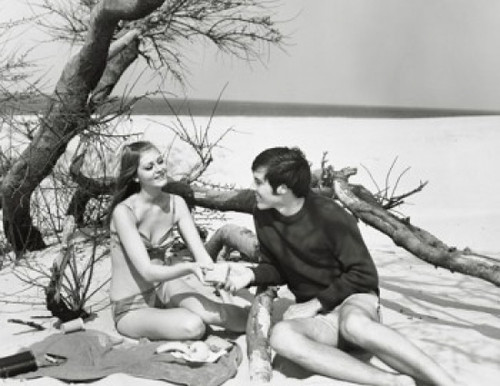 Young couple sitting on the beach Poster Print - Item # VARSAL25522080