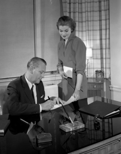 Young secretary giving document to mature businessman for signing Poster Print - Item # VARSAL25520861