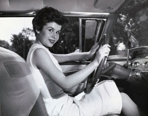 Young woman sitting in the driver's seat of a car and smiling Poster Print - Item # VARSAL2557877