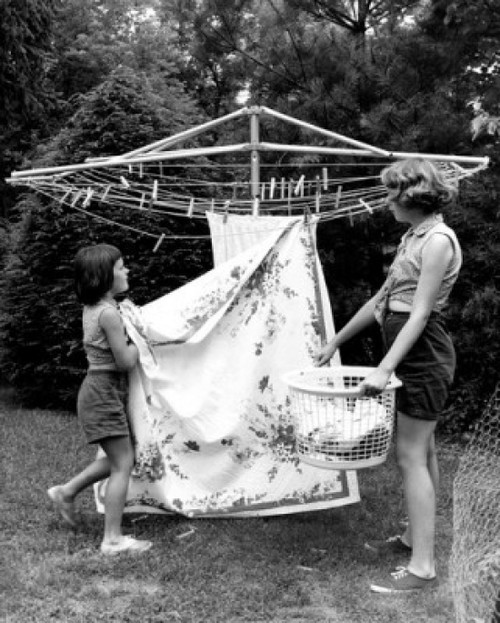 Mother and daughter hanging laundry in backyard Poster Print - Item # VARSAL25547950