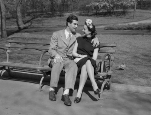 Happy young couple sitting on bench in park Poster Print - Item # VARSAL255418821
