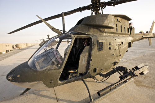 An OH-58D Kiowa helicopter sits on the tarmac at COB Speicher, Tikrit, Iraq, during Operation Iraqi Freedom Poster Print - Item # VARPSTTMO100750M