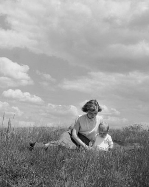 Young woman sitting with her baby in a field Poster Print - Item # VARSAL2559750