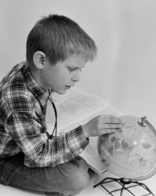 Boy looking at globe Poster Print - Item # VARSAL255416443