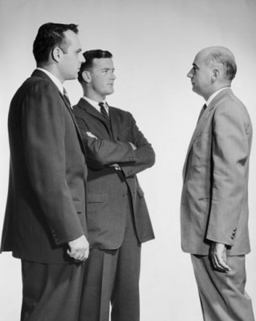 Businessman confronting two other businessmen Poster Print - Item # VARSAL25548009