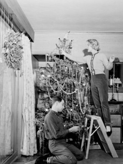 Couple decorating Christmas tree at home Poster Print - Item # VARSAL255422731