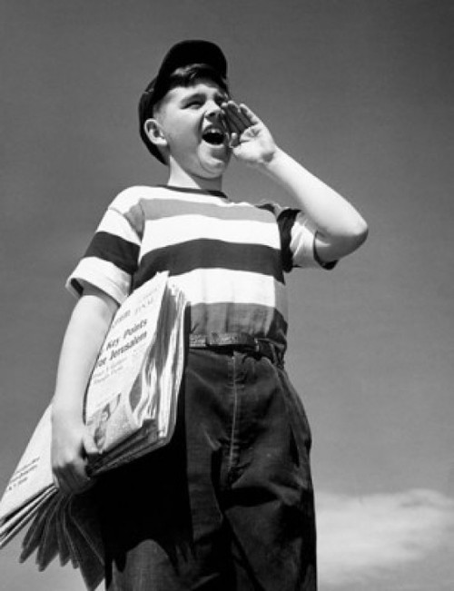 Low angle view of a boy selling newspapers Poster Print - Item # VARSAL25527393B