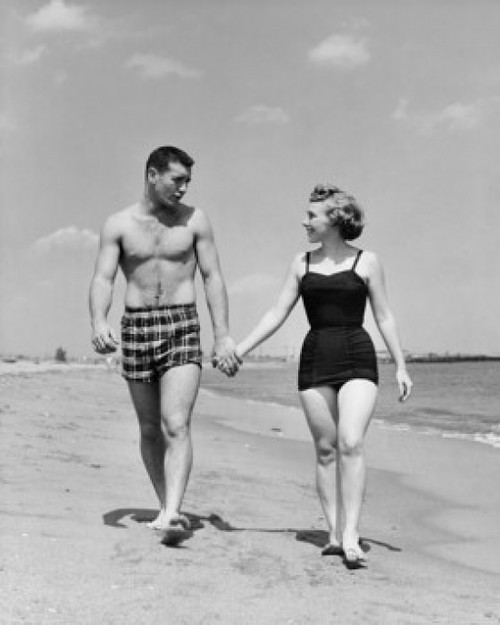 Young couple walking on beach Poster Print - Item # VARSAL25541124