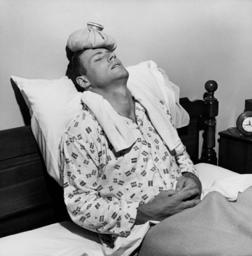 Mature man reclining on the bed with an ice pack on his head Poster Print - Item # VARSAL25533137