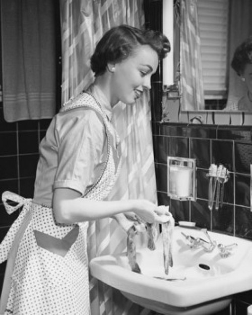 Side profile of a young woman hand washing clothes in the bathroom sink Poster Print - Item # VARSAL25541731