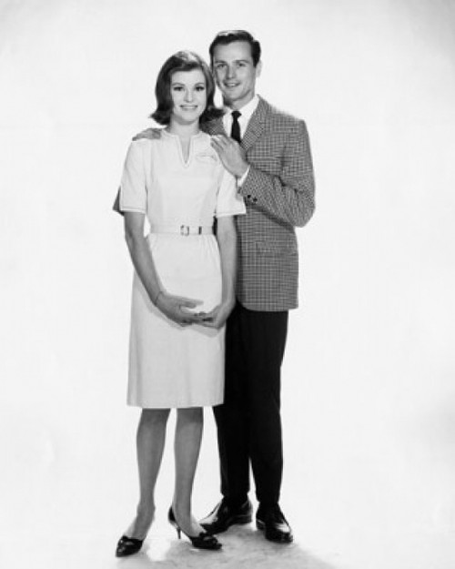 Young man standing with his arm around a young woman Poster Print - Item # VARSAL25541312