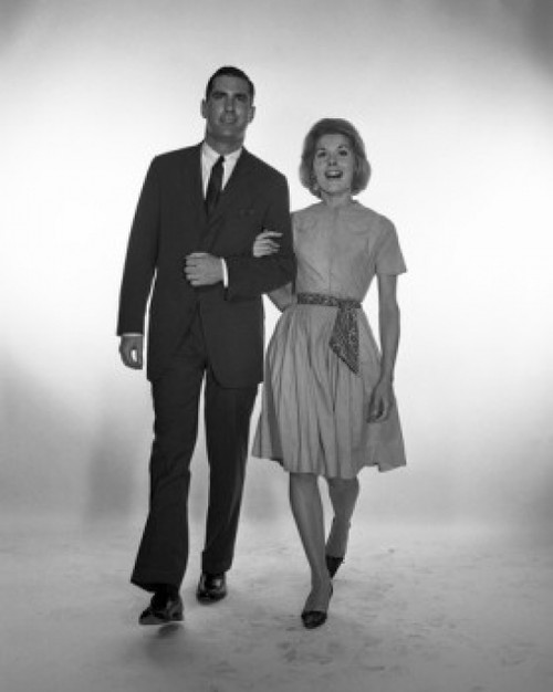 Happy mid adult couple walking  studio shot Poster Print - Item # VARSAL255417385