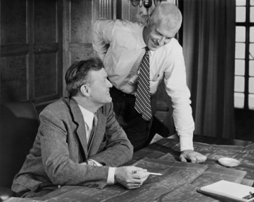 Two businessmen discussing blueprint in office Poster Print - Item # VARSAL25547974