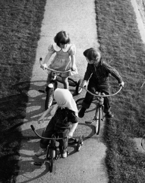 Children on tricycles Poster Print