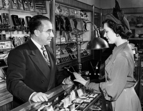 Mid adult woman buying jewelry in a jewelry store Poster Print - Item # VARSAL2551257