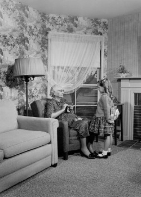 Little girl giving gift to grandmother at home Poster Print - Item # VARSAL255424860