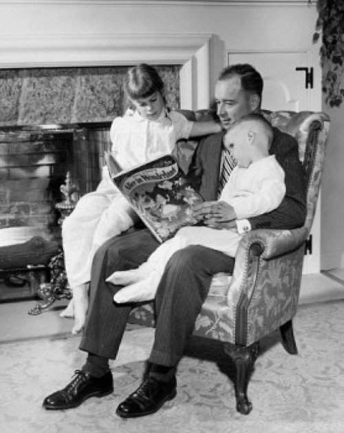 Father reading Alice in Wonderland to daughter and son Poster Print - Item # VARSAL25519473