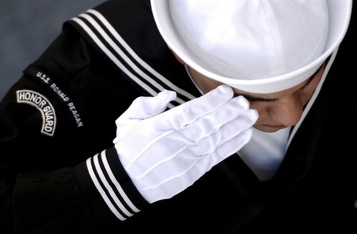 Pacific Ocean, December 2, 2004 - An Honor Guard member renders a salute during a burial at sea ceremony aboard USS Ronald Reagan. Poster Print - Item # VARPSTSTK100693M