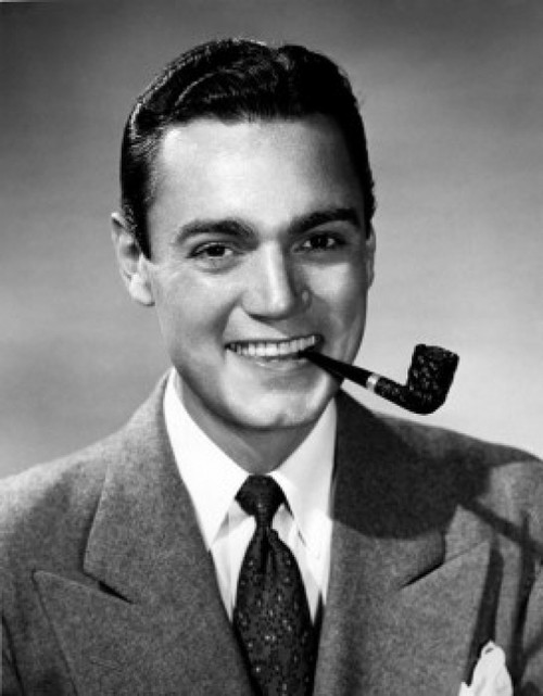 Studio portrait of young man smoking tobacco pipe Poster Print - Item # VARSAL25528261