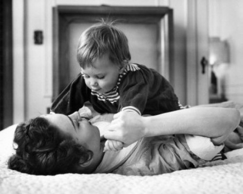 Young woman playing with baby on bed Poster Print - Item # VARSAL2559870