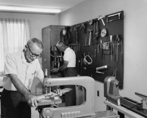Two senior men working in a workshop Poster Print